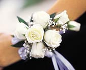 7 White Mini Roses Wristlet in Ellicott City MD, Wessel's Florist & Weddings